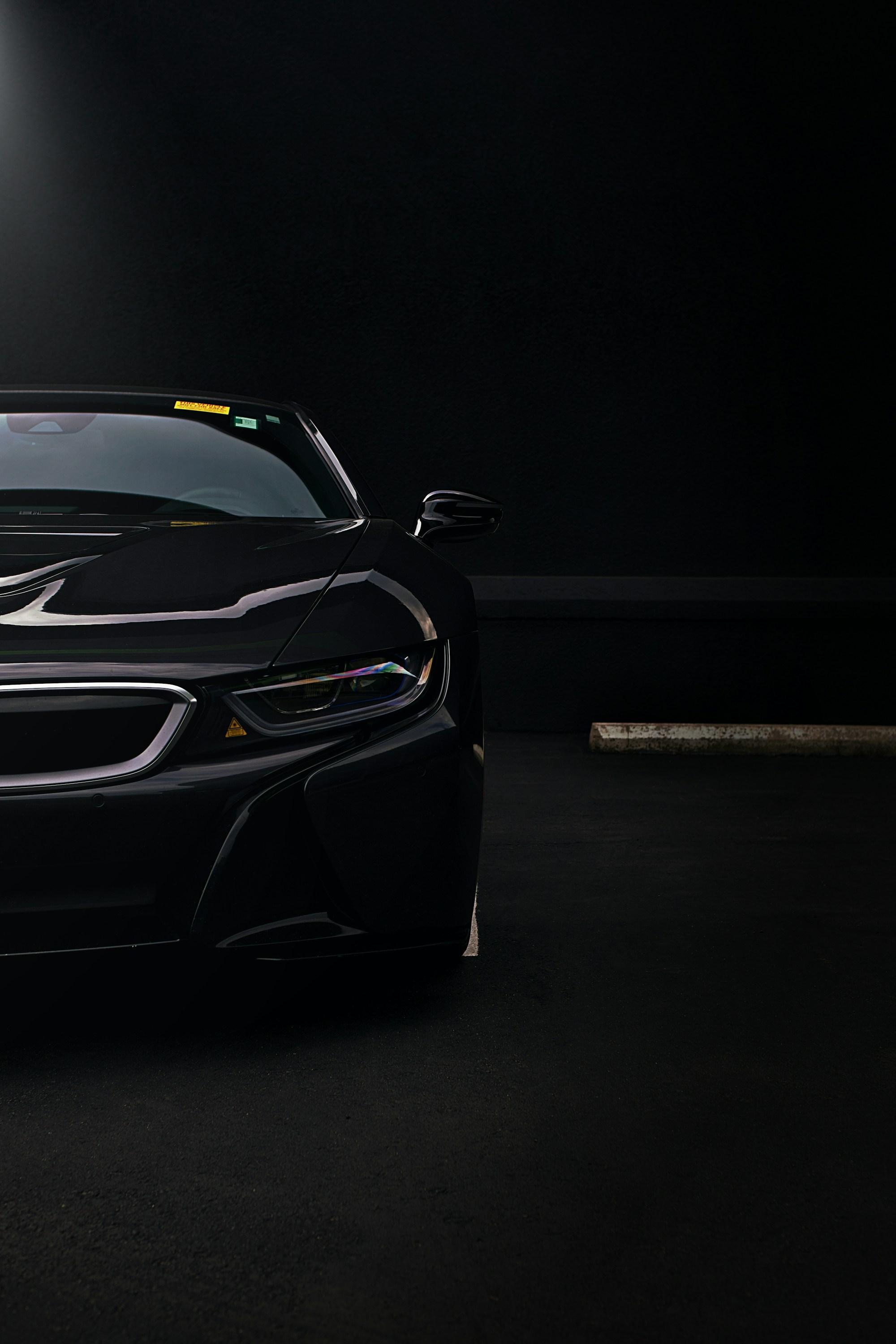 A sports car front in a dark garage
